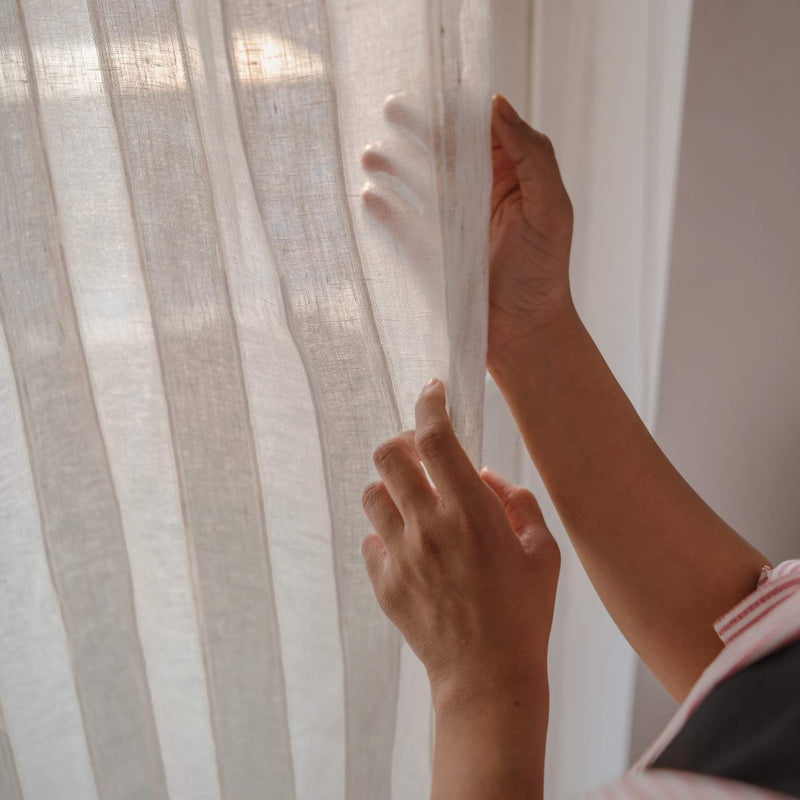 Close-up of striped linen curtain texture showing natural weave