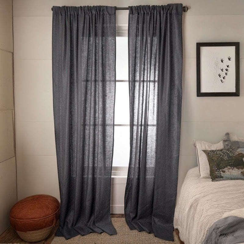 Charcoal linen semi-sheer curtains hanging in modern living room with natural light filtering through