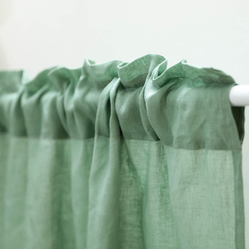 Close-up rod pocket hanging style of handcrafted sage green linen curtain 