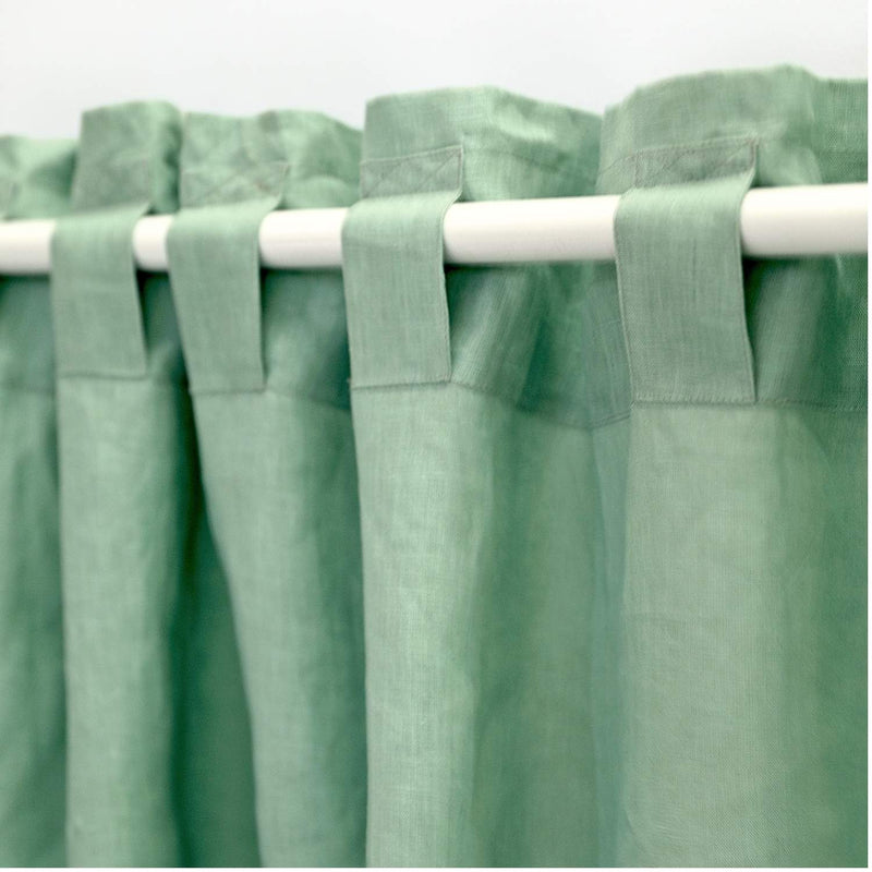 Close-up back tab hanging style of handcrafted sage green linen curtain fabric