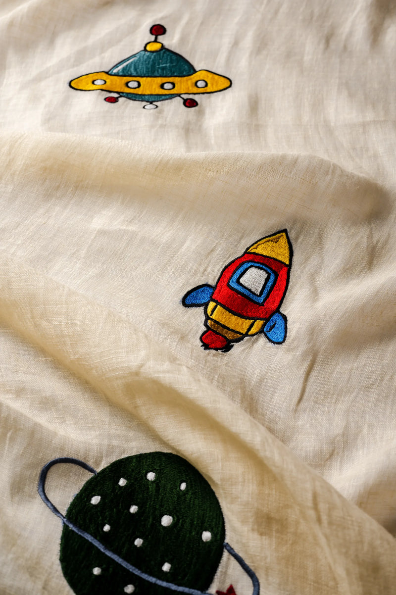 Yellow linen sheer curtains with hand-embroidered space theme featuring spaceships and astronauts in nursery setting